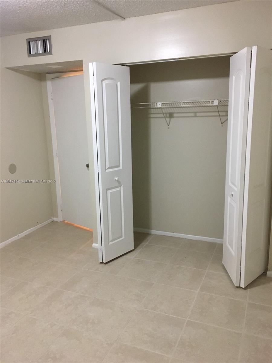 4170 Inverrary Drive, Unit 111 Lauderhill, FL 33319 - Photo 21 of 28 an empty room with closet