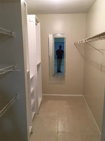 a view of a big room with closet and wooden floor