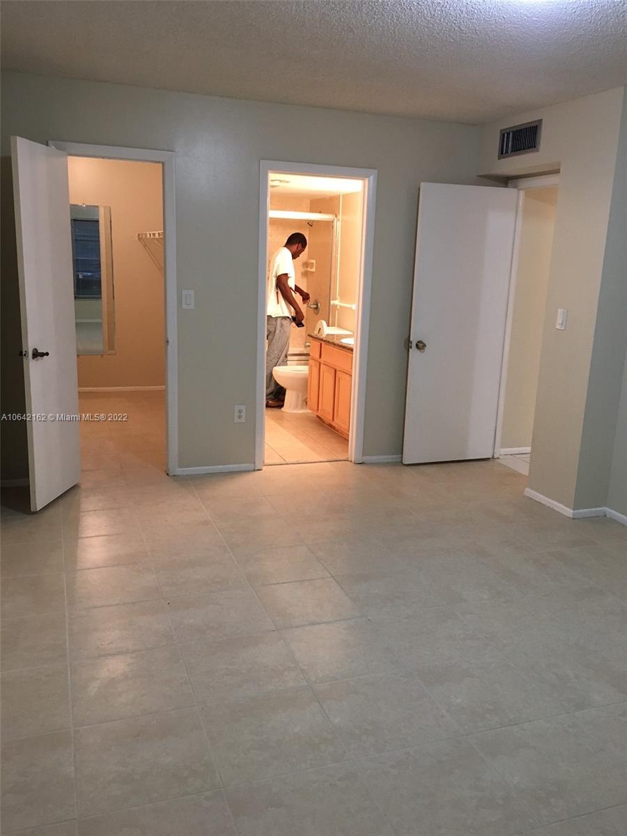 4170 Inverrary Drive, Unit 111 Lauderhill, FL 33319 - Photo 25 of 28 a view of a big room with closet and wooden floor