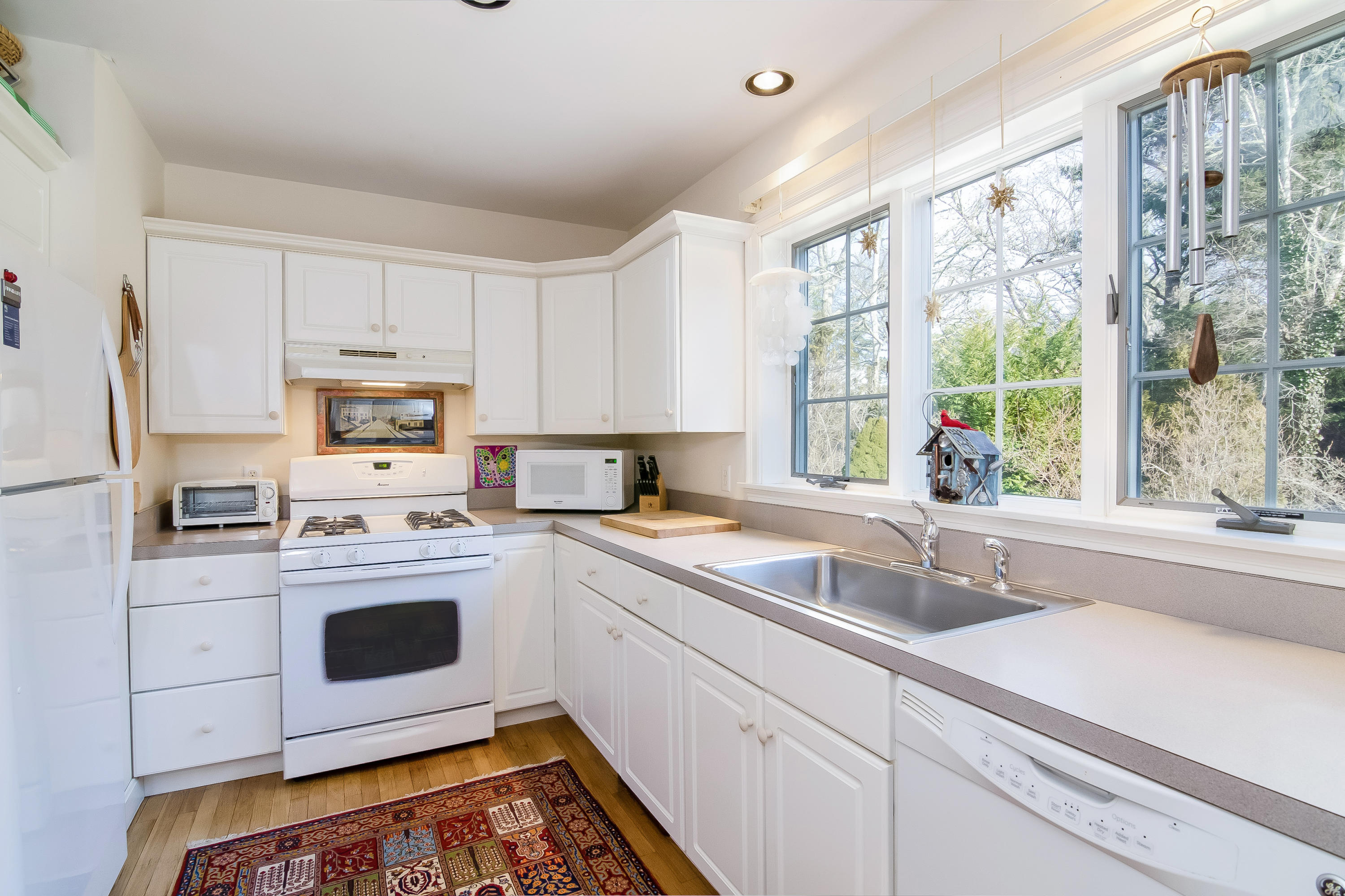 192 Round Cove Road Chatham, MA 02633 - Photo 8 of 27 a kitchen with stainless steel appliances white cabinets and a sink