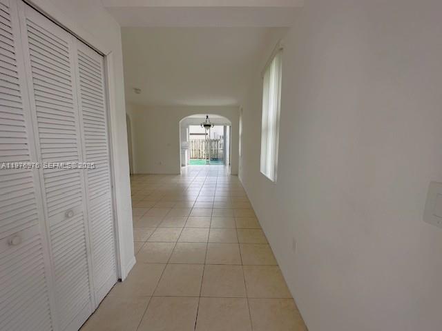 a view of a hallway with wooden floor and a bathroom