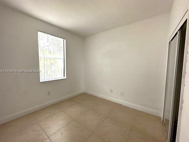 13840 Southwest 273rd Terrace Homestead, FL 33032 - Photo 7 of 9 an empty room with a window