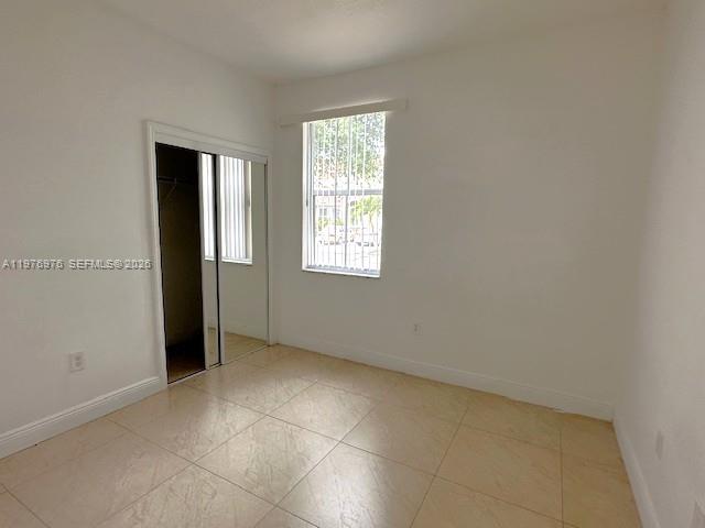 13840 Southwest 273rd Terrace Homestead, FL 33032 - Photo 8 of 9 an empty room with windows