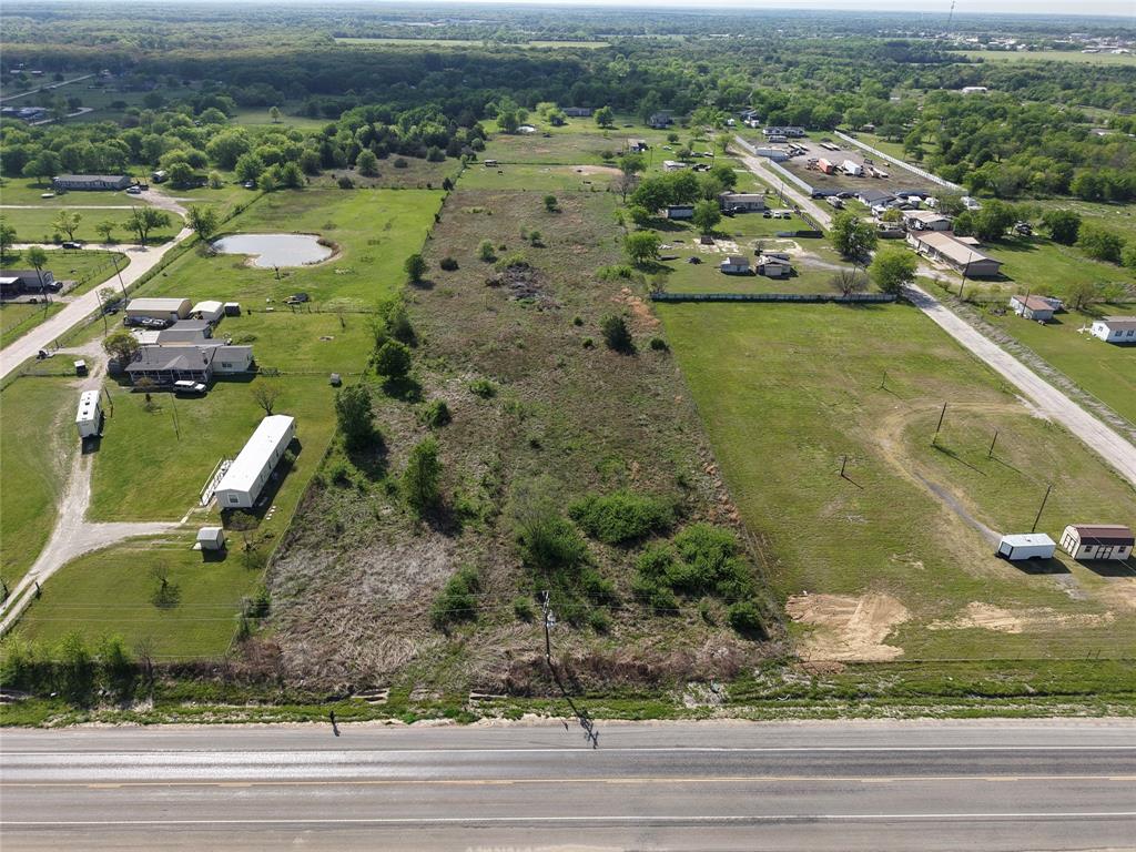 an aerial view of residential houses with outdoor space and parking