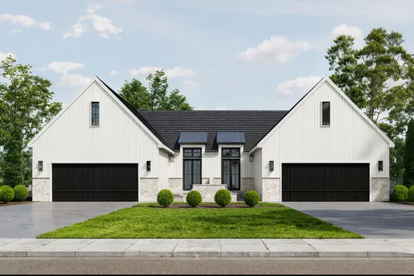 a front view of house with garage and green space