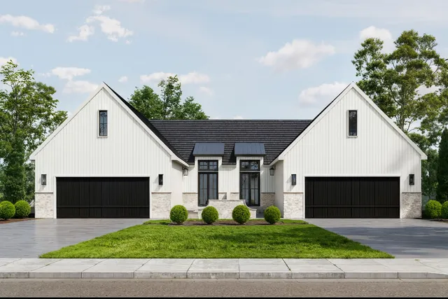 a front view of house with garage and green space