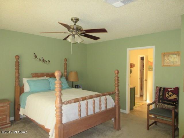 1022 Via Independencia Rio Rico, AZ 85648 - Photo 16 of 41 a bedroom with a bed and a chandelier