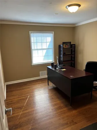 a living room with furniture window and a wooden floor