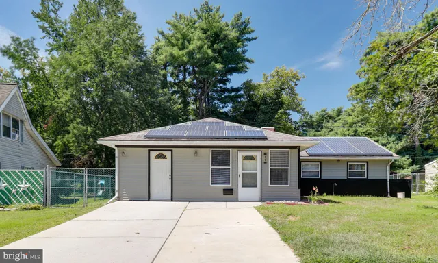 a front view of a house with a yard table and chairs
