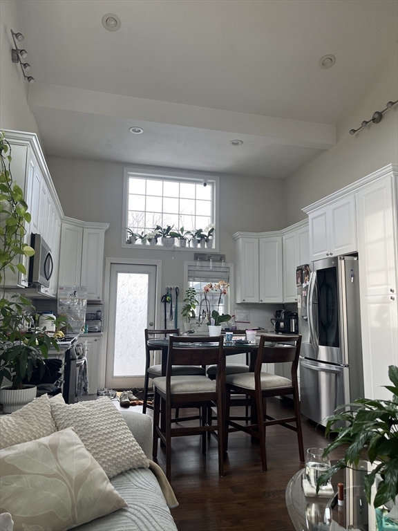 41 Jean Street Acushnet, MA 02743 - Photo 11 of 21 a kitchen with stainless steel appliances a dining table chairs refrigerator and sink