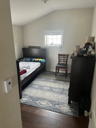 a bedroom with a bed and a tv