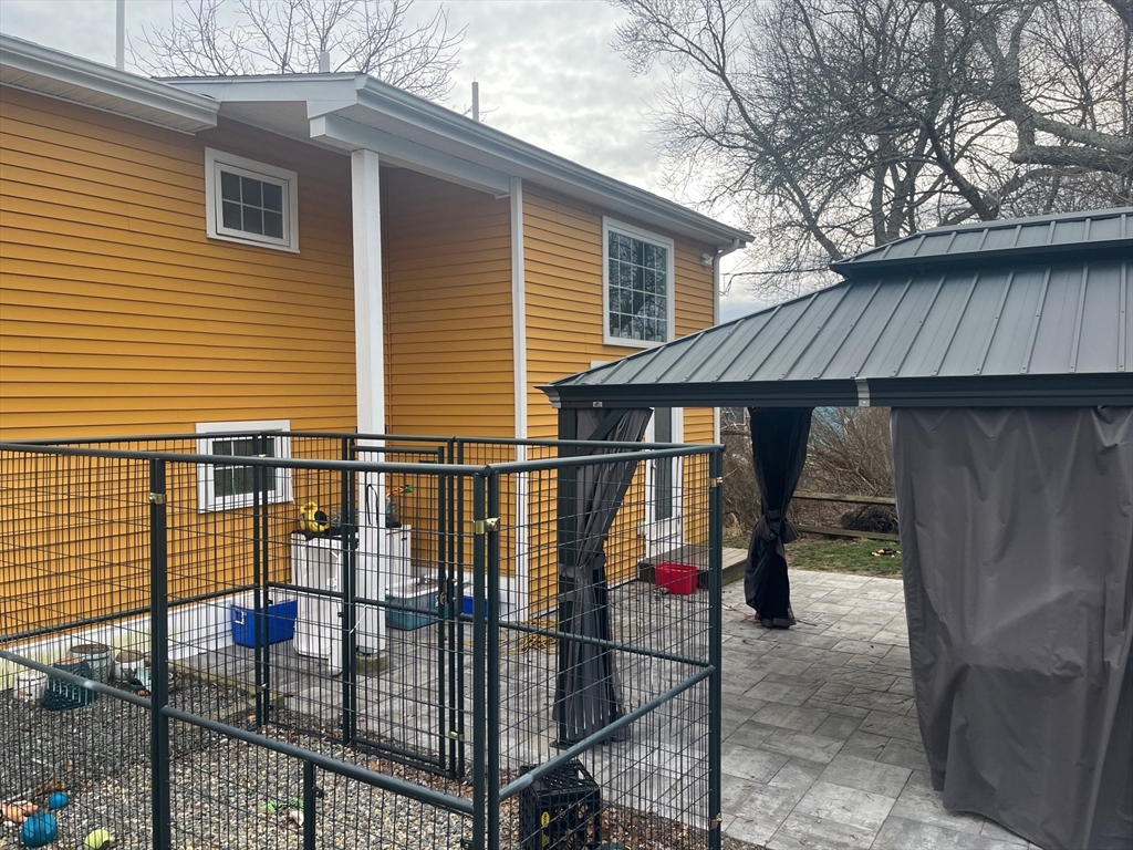 41 Jean Street Acushnet, MA 02743 - Photo 3 of 21 a view of backyard with small cabin and wooden fencing