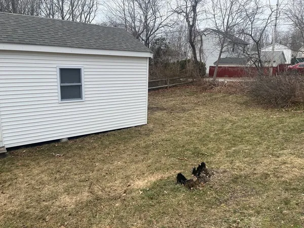 a backyard of a house with table and chairs
