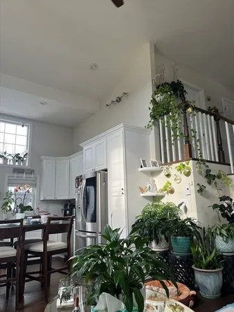a view of kitchen with furniture and refrigerator