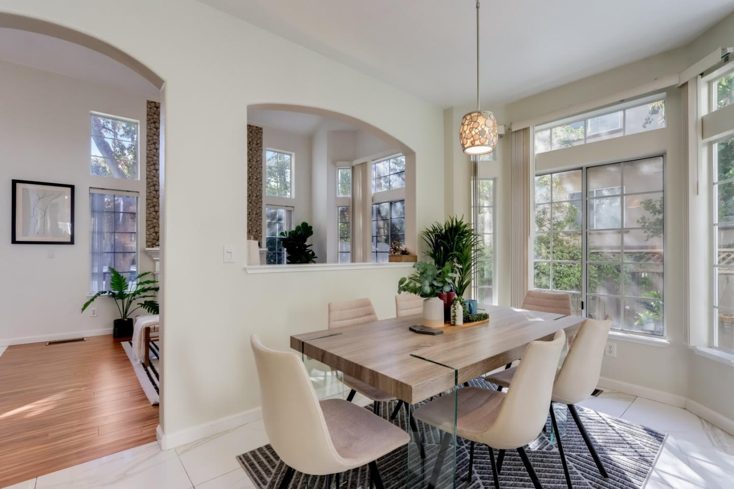 2373 Homestead Road Santa Clara, CA 95050 - Photo 6 of 30 a dining room with furniture potted plants and wooden floor