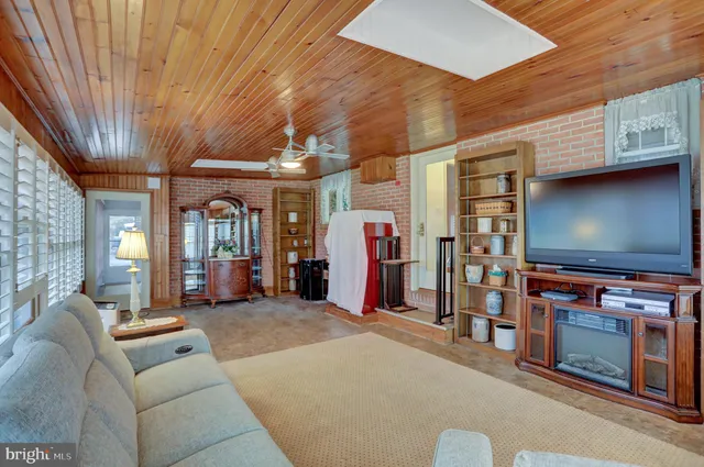 a view of a dining room with furniture and a chandelier