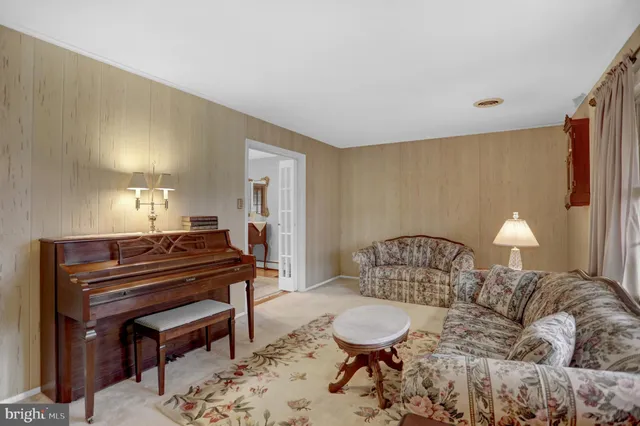 a bedroom with a bed window and a chandelier