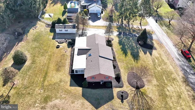 a view of a house with a yard covered in snow