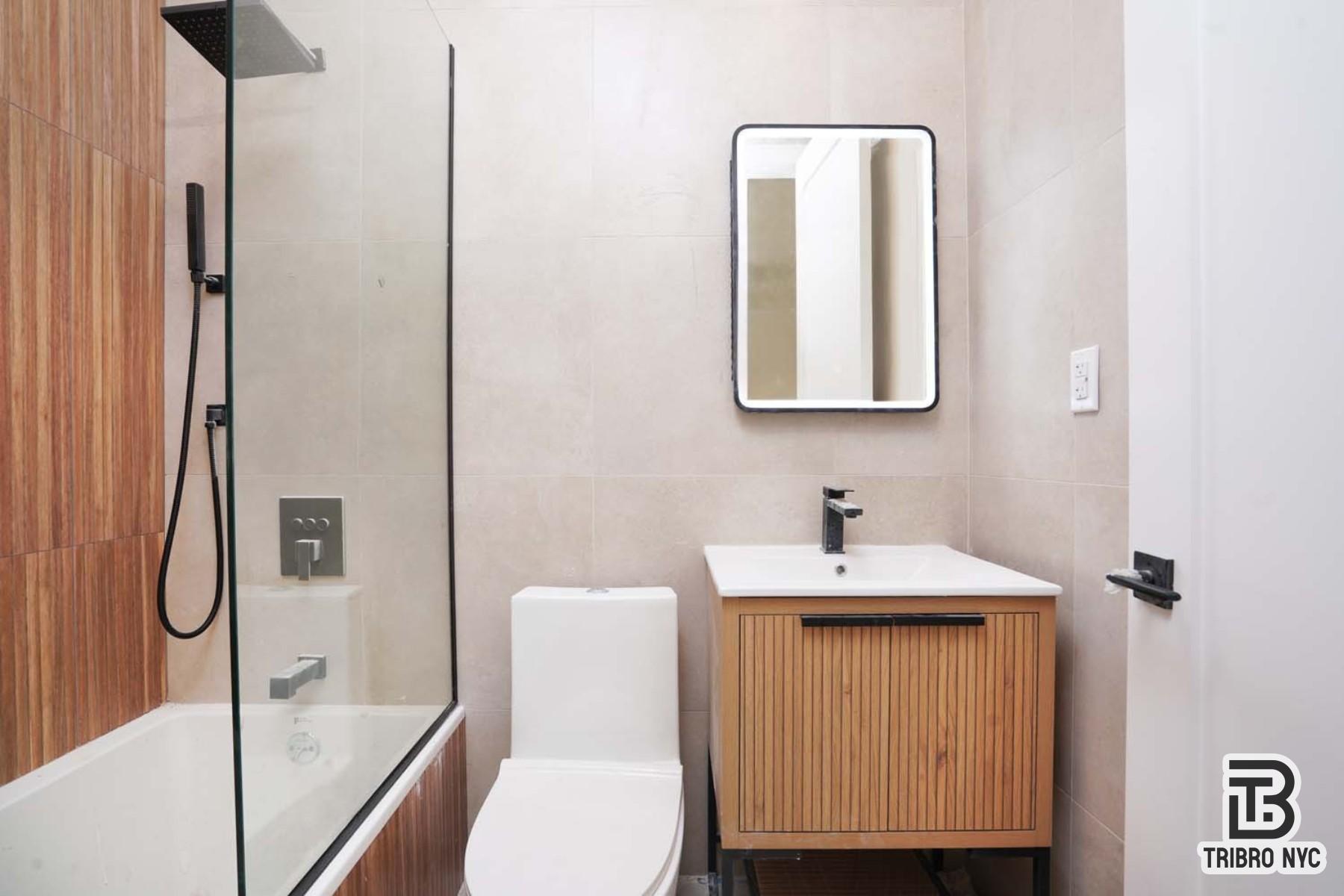 92 Manhattan Avenue, Unit 1B Brooklyn, NY 11206 - Photo 8 of 9 a bathroom with a sink toilet and shower