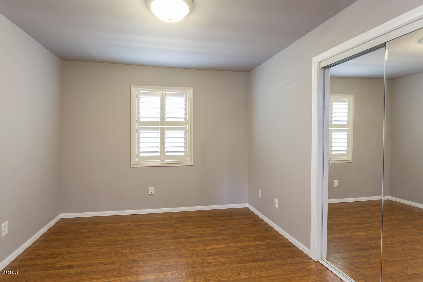 931 Walnut Canyon Road Moorpark, CA 93021 - Photo 14 of 27 a view of an empty room with wooden floor and a window