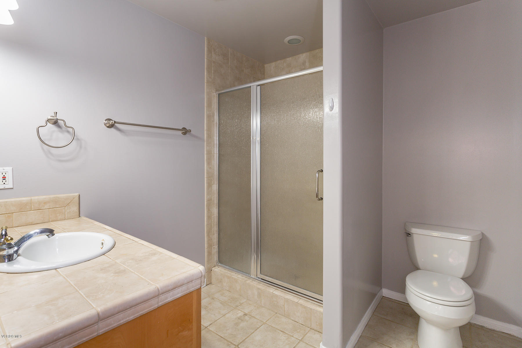 931 Walnut Canyon Road Moorpark, CA 93021 - Photo 15 of 27 a bathroom with a granite countertop toilet and a sink
