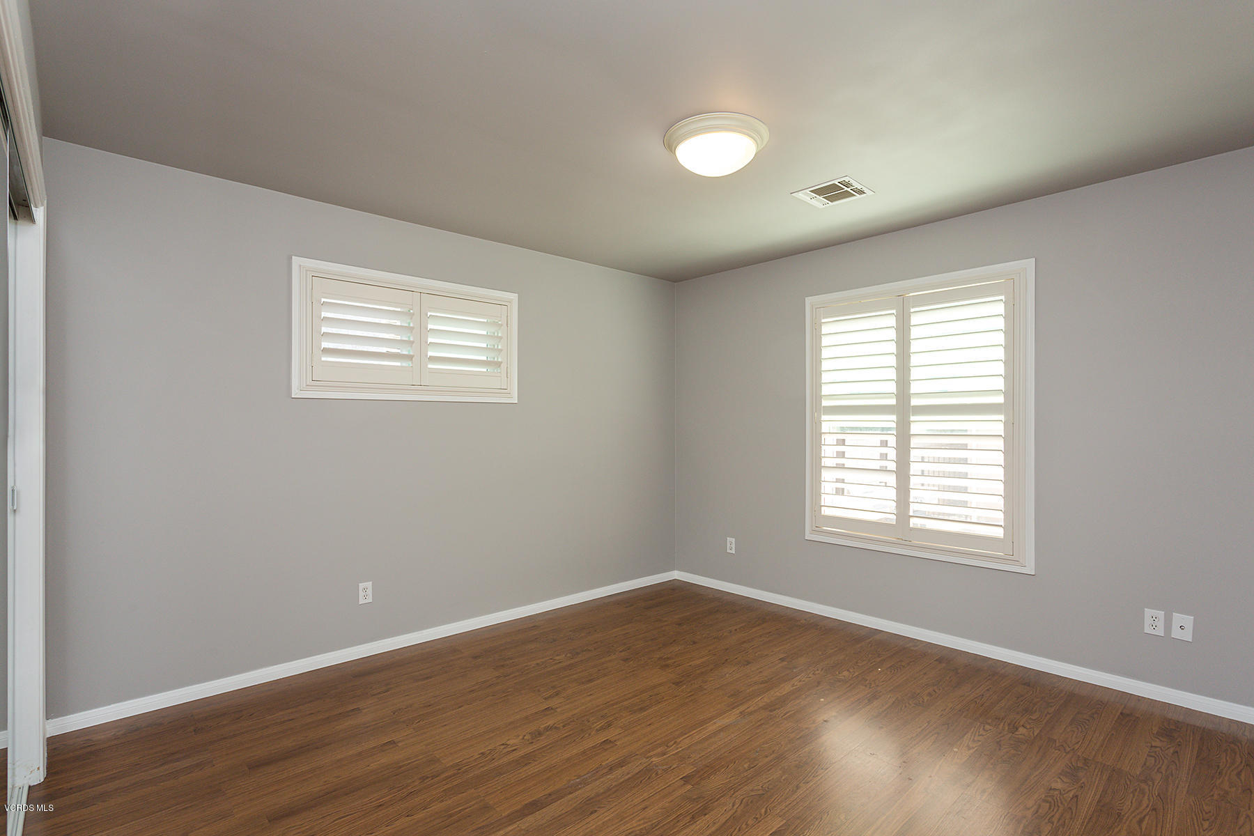 931 Walnut Canyon Road Moorpark, CA 93021 - Photo 17 of 27 an empty room with wooden floor and windows