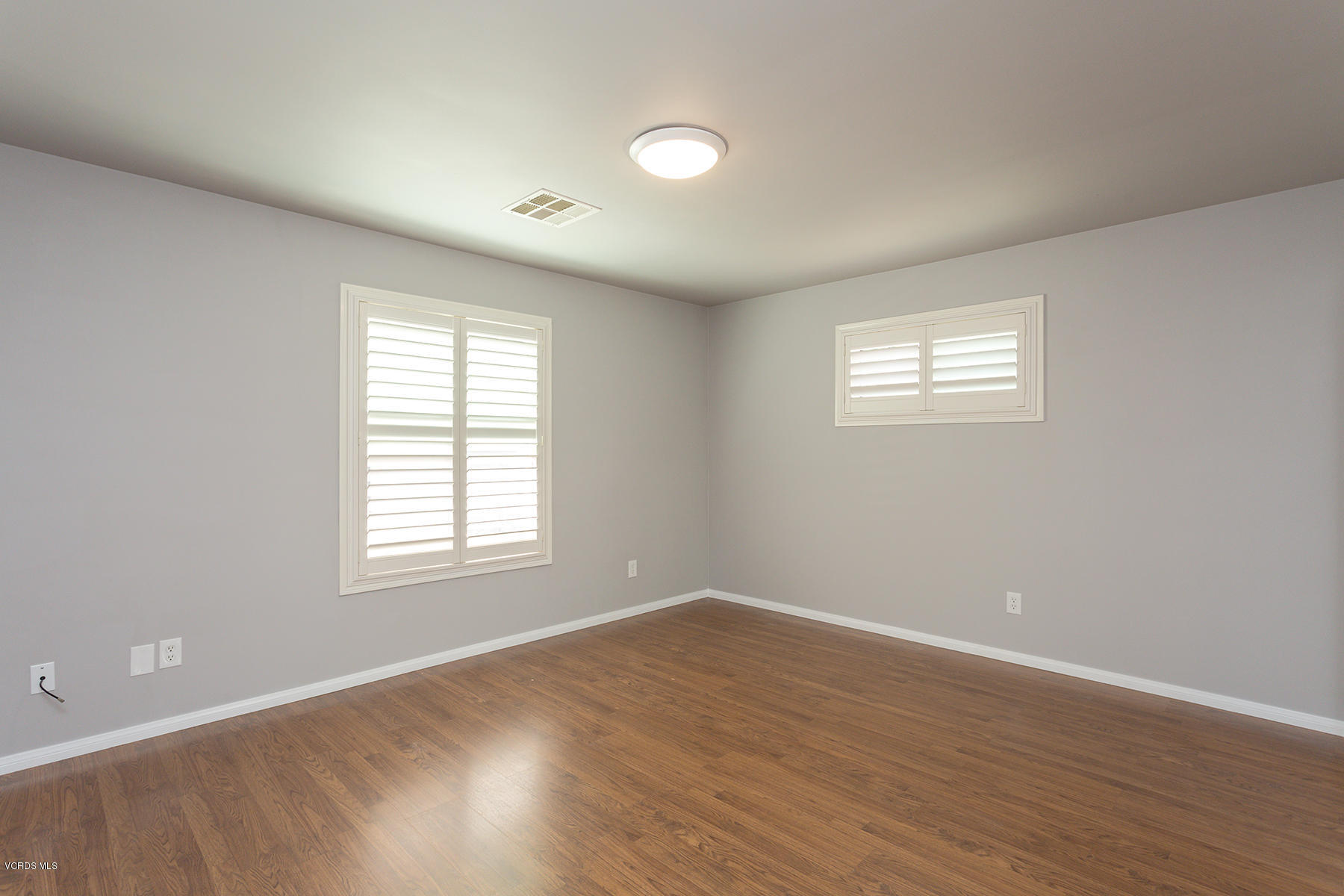 931 Walnut Canyon Road Moorpark, CA 93021 - Photo 19 of 27 an empty room with wooden floor and windows