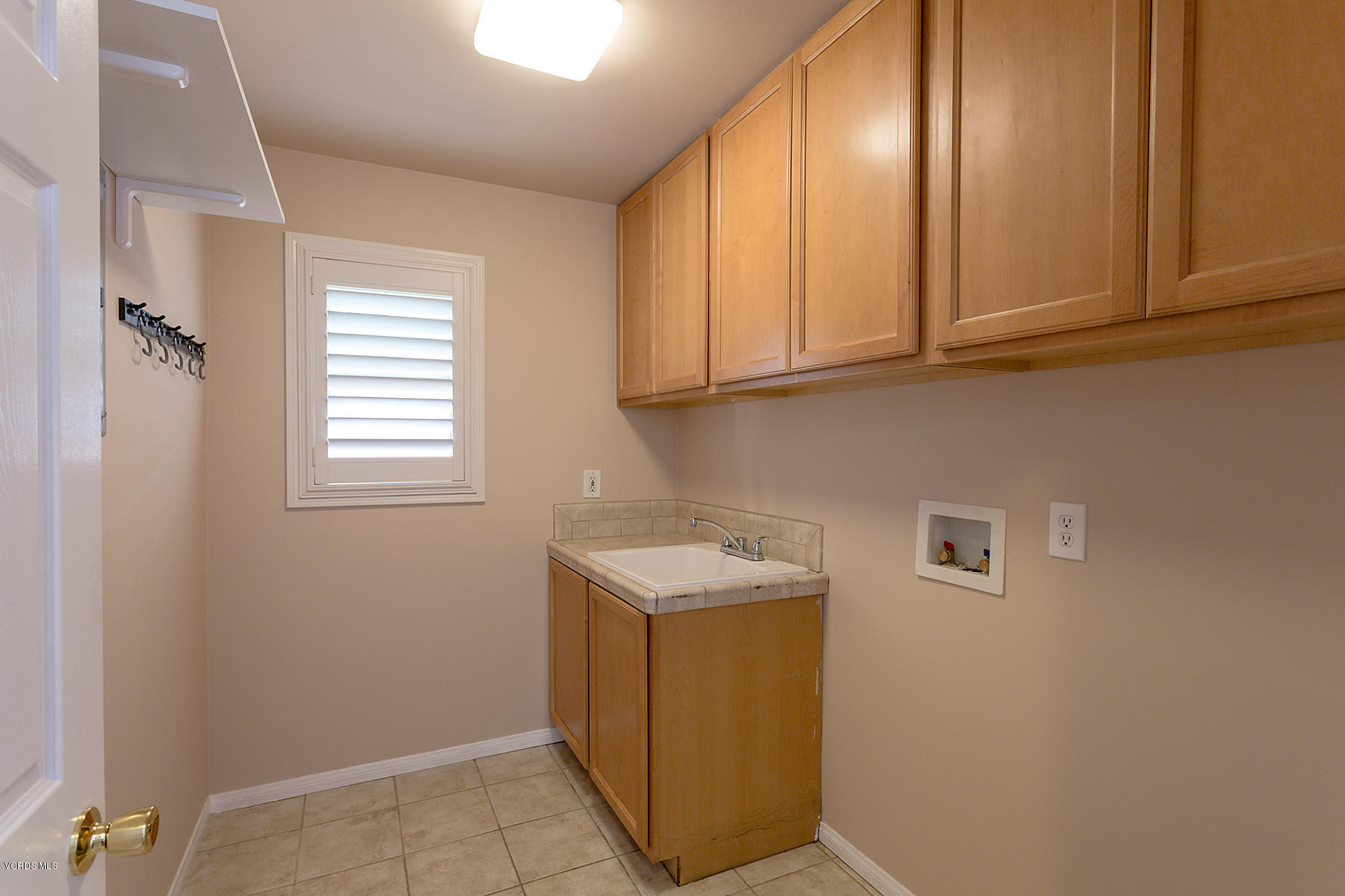 931 Walnut Canyon Road Moorpark, CA 93021 - Photo 21 of 27 a utility room with a sink a washer and dryer