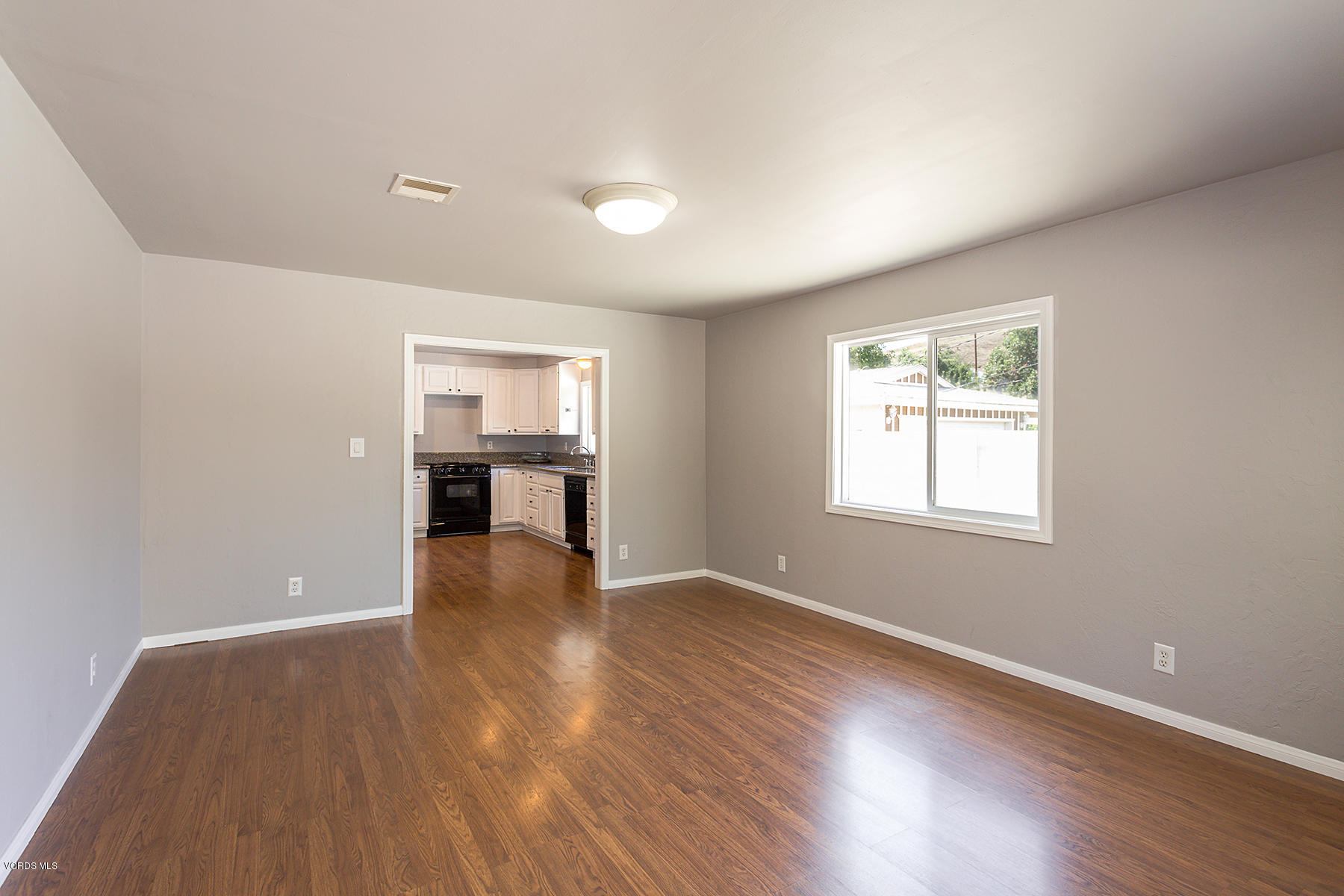 931 Walnut Canyon Road Moorpark, CA 93021 - Photo 4 of 27 an empty room with wooden floor and windows