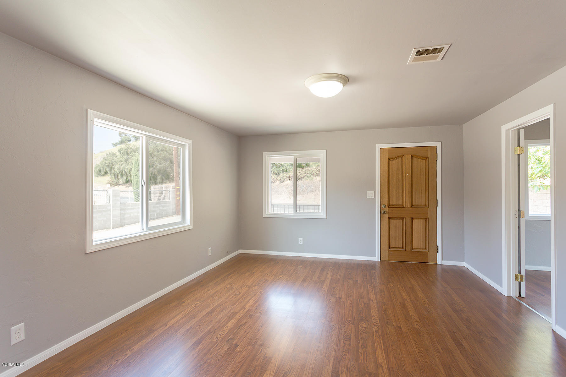 931 Walnut Canyon Road Moorpark, CA 93021 - Photo 5 of 27 a view of an empty room with wooden floor and a window