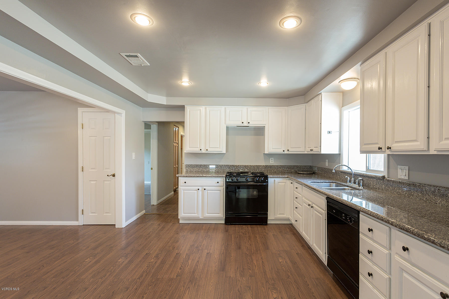 931 Walnut Canyon Road Moorpark, CA 93021 - Photo 7 of 27 a large kitchen with stainless steel appliances granite countertop a stove top oven a sink and dishwasher with wooden floor