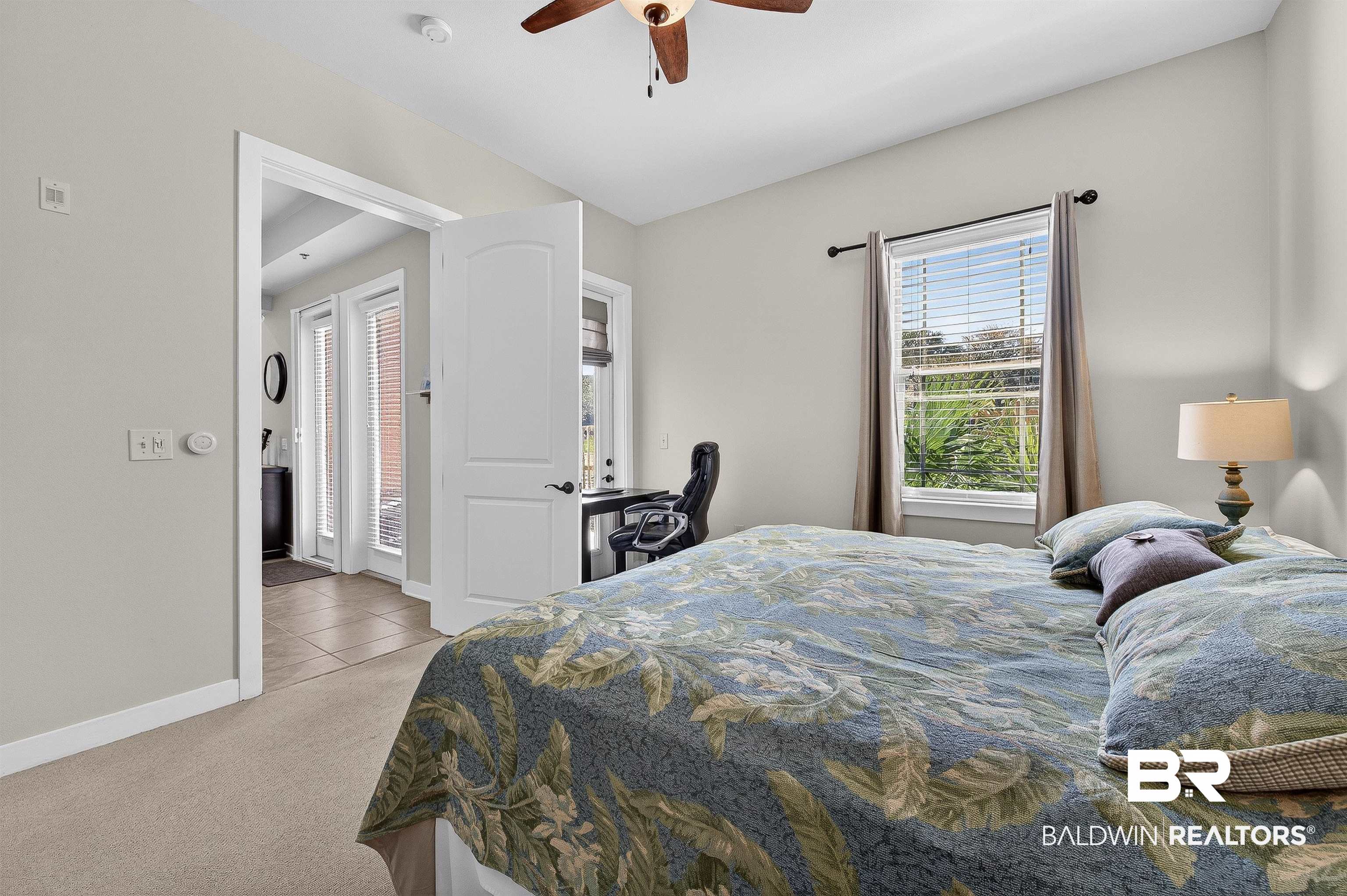1430 West Regency Road, Unit I102 Gulf Shores, AL 36542 - Photo 14 of 31 Bedroom with multiple windows, light carpet, and a ceiling fan