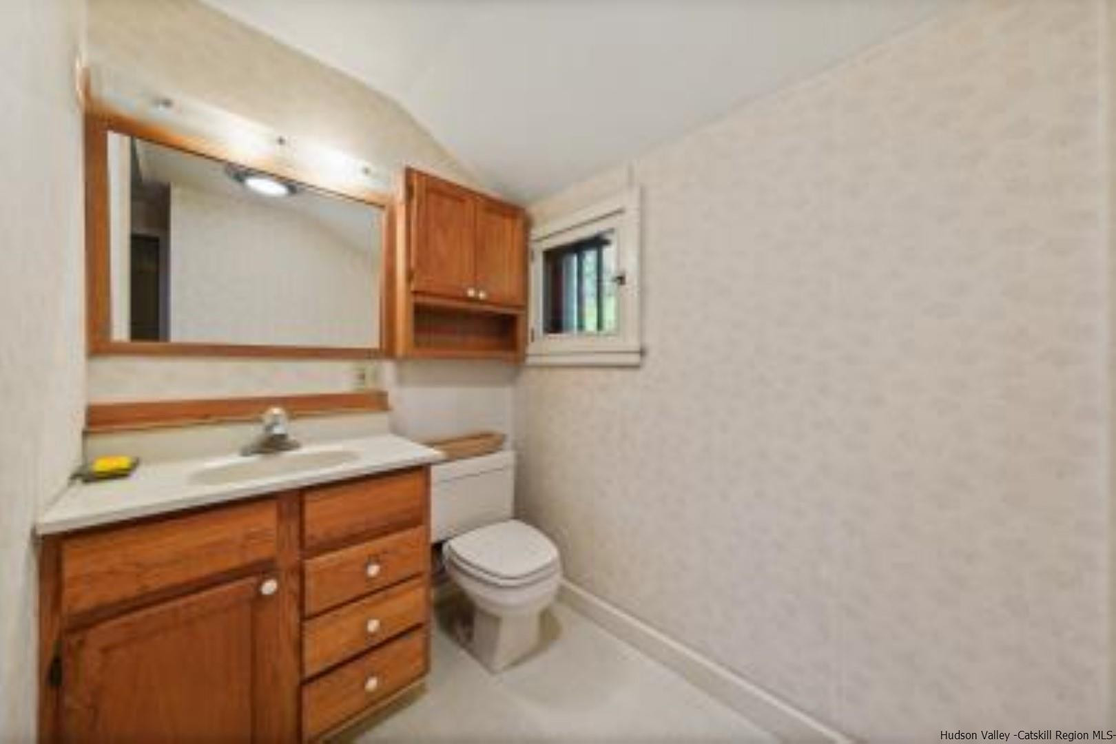 344 Scarawan Road Stone Ridge, NY 12484 - Photo 11 of 30 a bathroom with a granite countertop toilet sink and mirror
