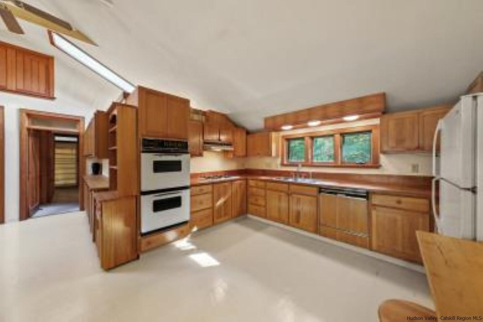 344 Scarawan Road Stone Ridge, NY 12484 - Photo 7 of 30 a kitchen with stainless steel appliances a refrigerator and wooden cabinets