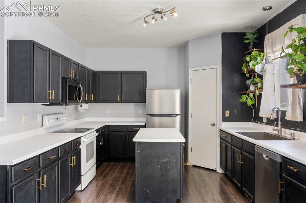 7509 Sistine Lane Fountain, CO 80817 - Photo 13 of 22 a kitchen with a sink cabinets and wooden floor