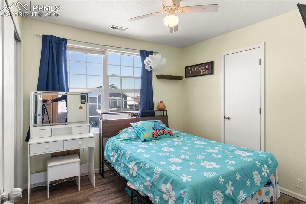7509 Sistine Lane Fountain, CO 80817 - Photo 16 of 22 a bedroom with a bed a table and chair