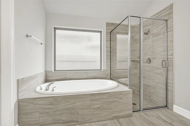 a bathroom with a bathtub and shower