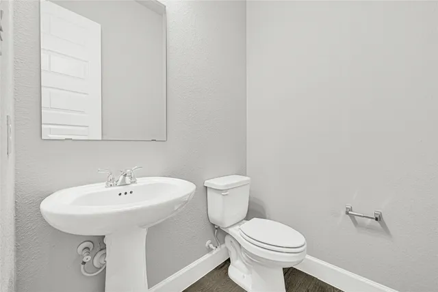 a white toilet sitting next to a bathroom sink