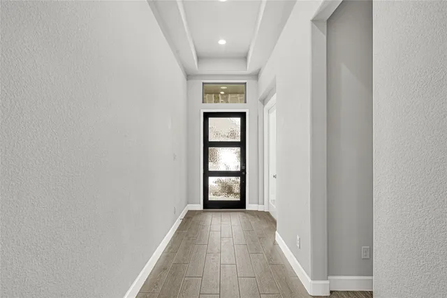 wooden floor in a room next to a window