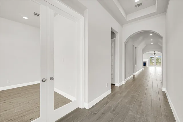 a view of a hallway with wooden floor