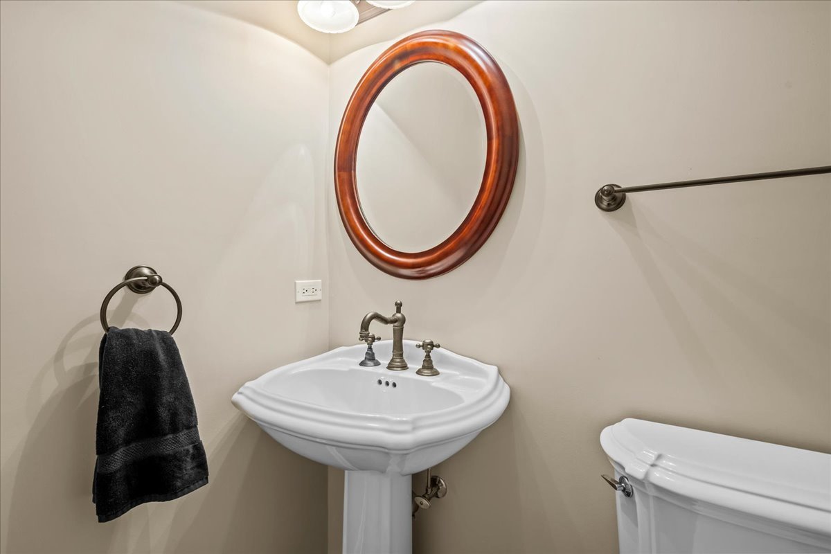 738 Lyster Road Highwood, IL 60040 - Photo 10 of 16 a bathroom with a toilet sink and mirror