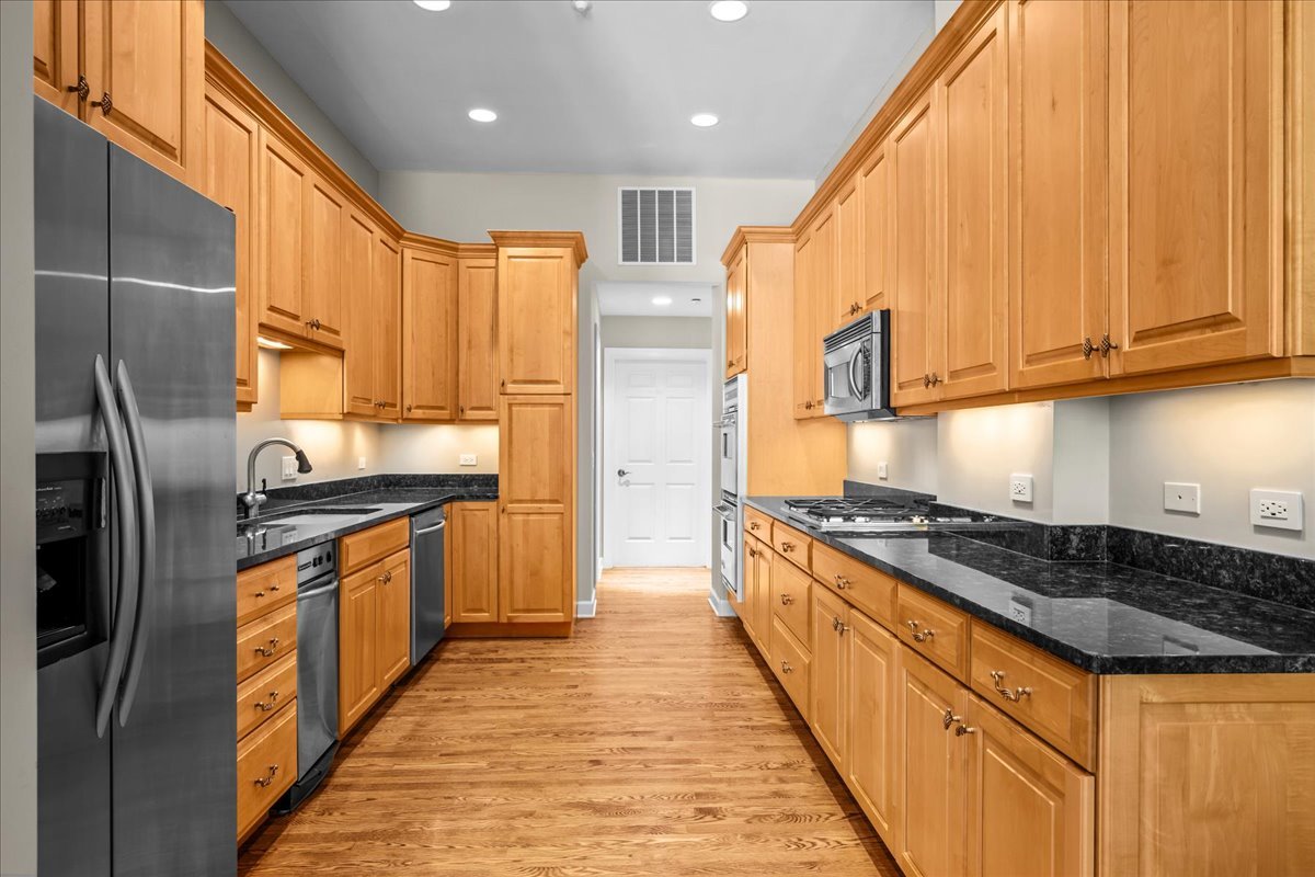 738 Lyster Road Highwood, IL 60040 - Photo 3 of 16 a kitchen with stainless steel appliances granite countertop a stove a sink and a refrigerator