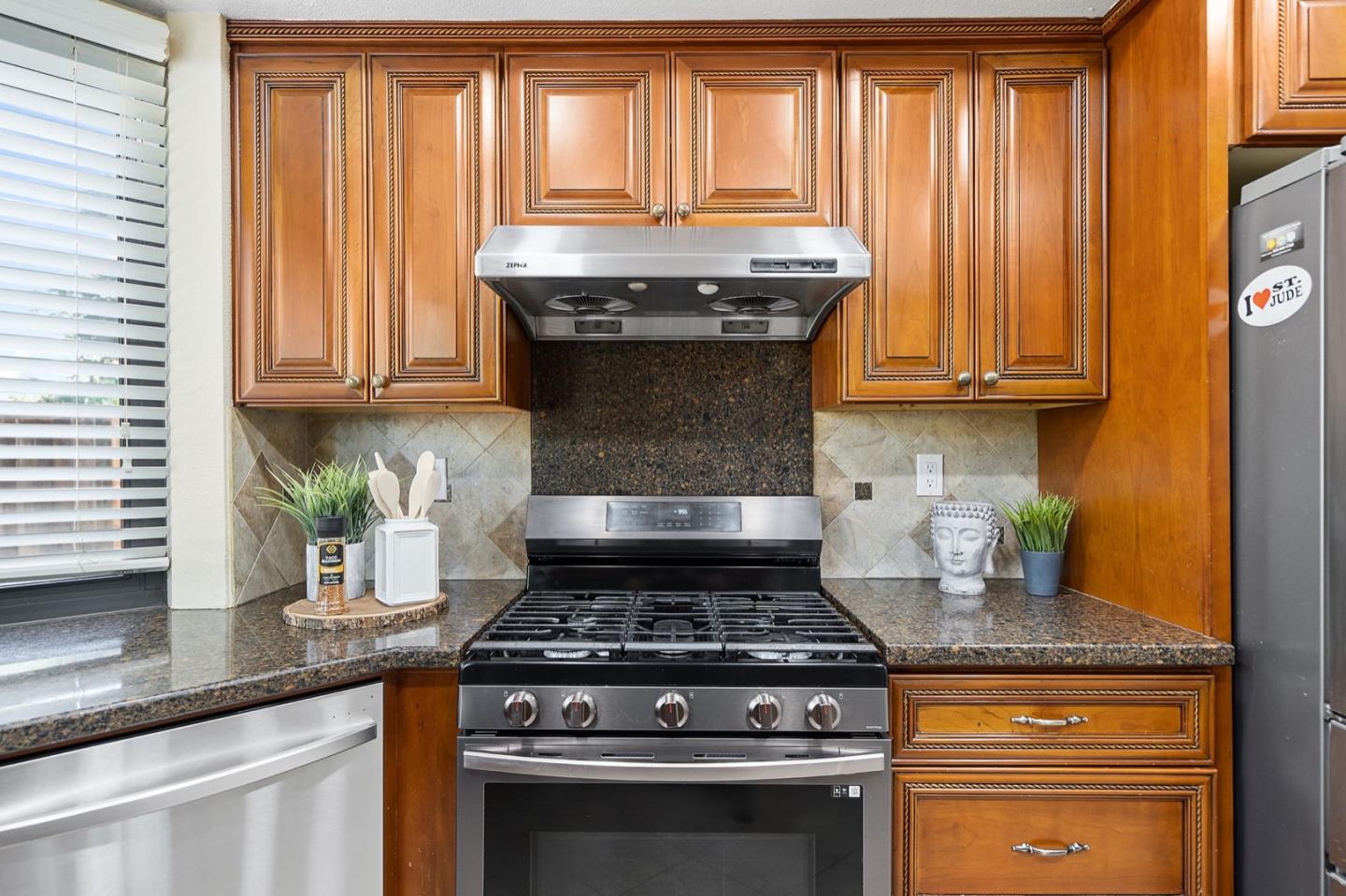 229 Michigan Road Milpitas, CA 95035 - Photo 7 of 38 a stove top oven sitting inside of a kitchen