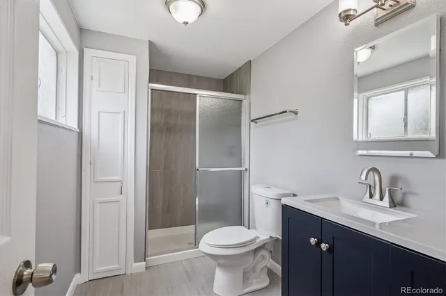 a bathroom with a sink toilet and shower