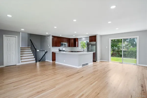 a view of kitchen with cabinets and wooden floor