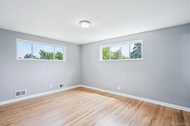 a view of room with window and wooden floor