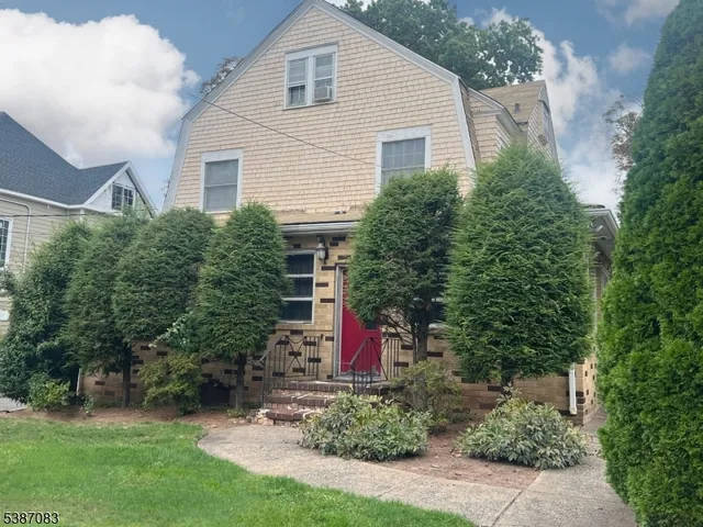 a view of a house with a yard and plants