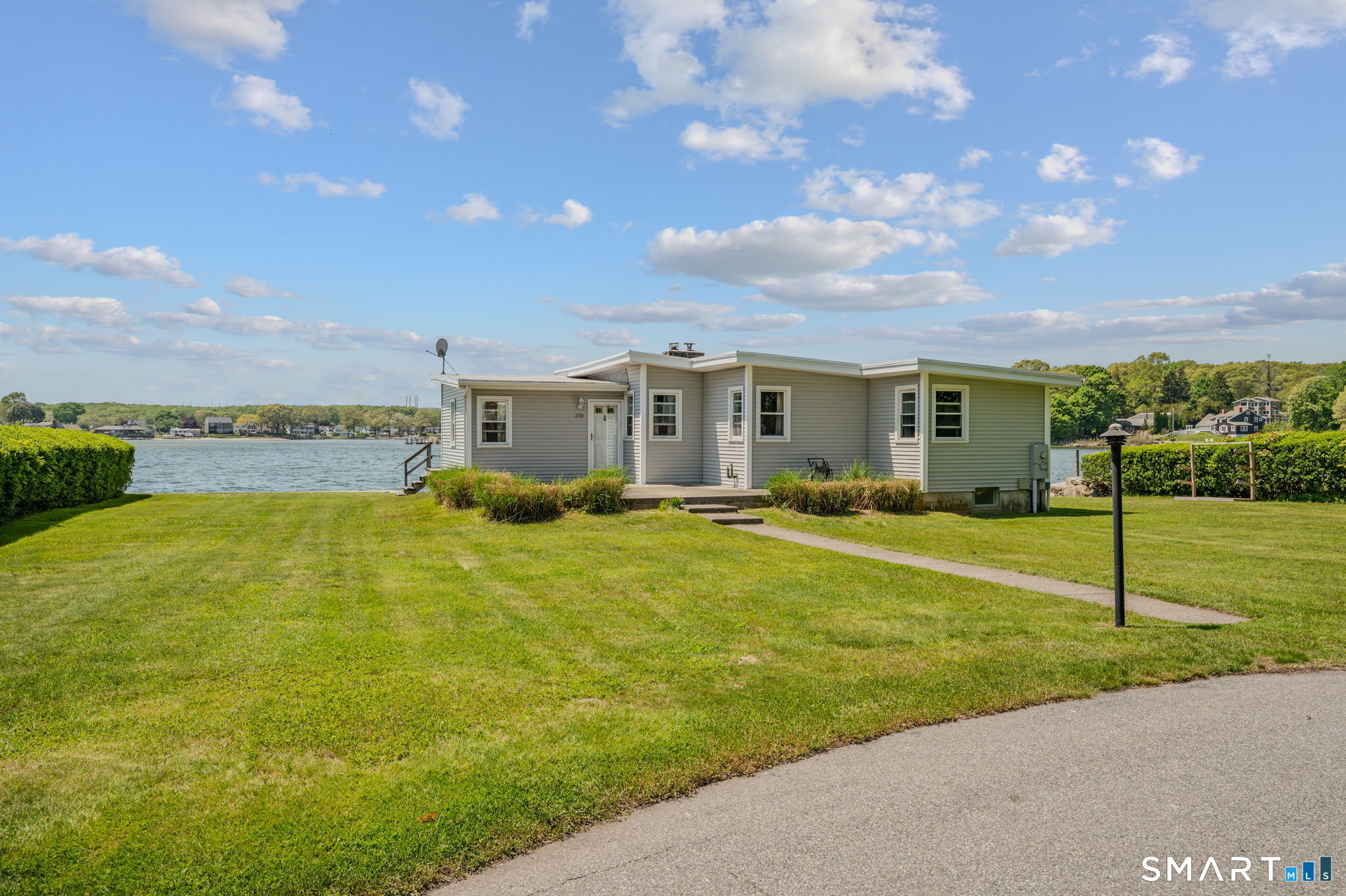 210 Shore Road Waterford, CT 06385 - Photo 2 of 26 a view of an house with swimming pool and yard