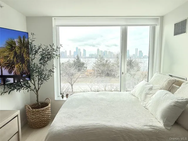 a bed sitting in a bedroom next to a window