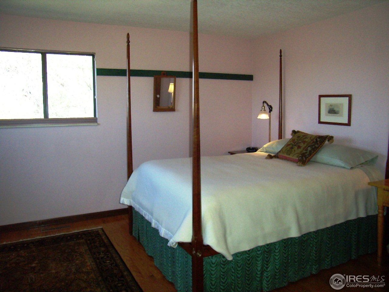 10107 Phillips Road Lafayette, CO 80026 - Photo 12 of 22 a bedroom with a bed and a window